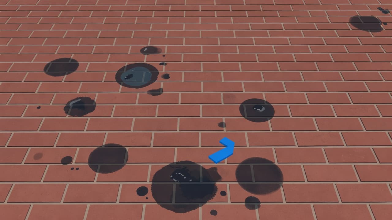 Close-up of oil stains on brick patio with dark circular grease spots on reddish-brown pavers