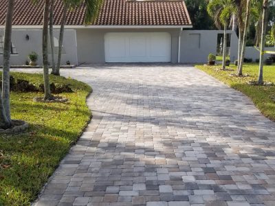 pavers in front of gray house after cleaning