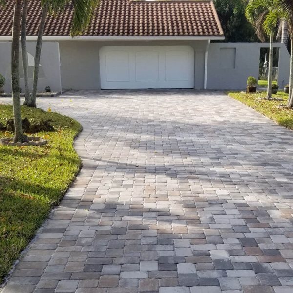 pavers in front of gray house after cleaning