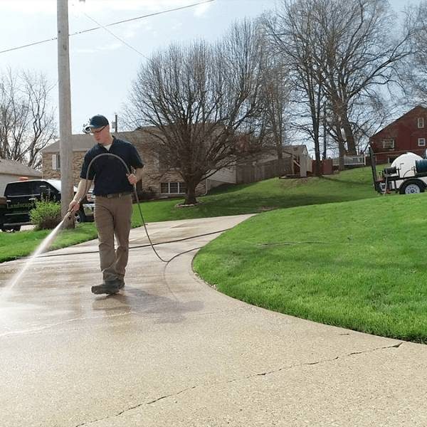 pressure washing professional washing concrete with work truck